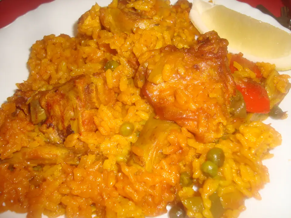 Paella valenciana tradicional con pollo y verduras, sin marisco